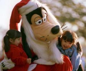 Puzzle Goofy déguisé en Père Noël serrant deux filles