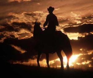 Puzzle Cowboy montant un cheval ou à la tombée de la nuit