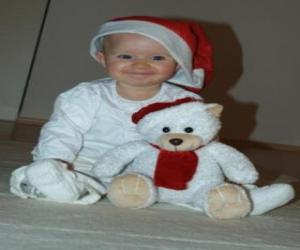 Puzzle Garçon avec un chapeau de Père Noël avec son ours en peluche