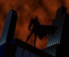 Batman, l'homme chauve-souris, en rsurveillant la ville du toit d'un bâtiment à Gotham City