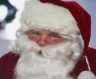 Visage souriant du Père Noël avec sa longue barbe et son chapeau