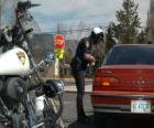 Motorisée agent de police avec sa moto et mettre une amende à un conducteur