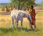 Guerrier indien avec son cheval près du camp de