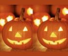 citrouilles de Halloween avec un visage sculpté et une bougie allumée à l'intérieur ou Jack-o'-lantern