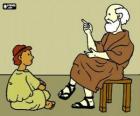 Professeur ou enseignant, assis sur un tabouret, d'enseigner un jeune garçon, assis sur le plancher