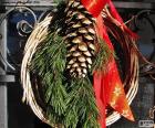 Couronne de Noël rustique faite avec des matériaux naturels et un rouge ruban d’étoiles
